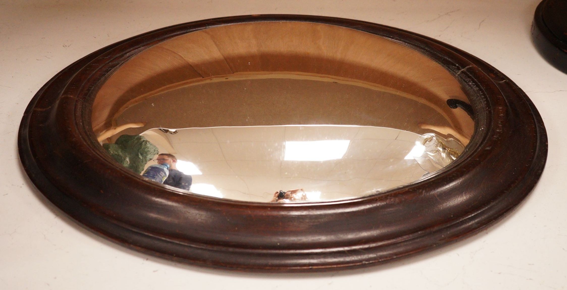 An unusual 19th century oval framed convex wall mirror, 44x54cm including frame